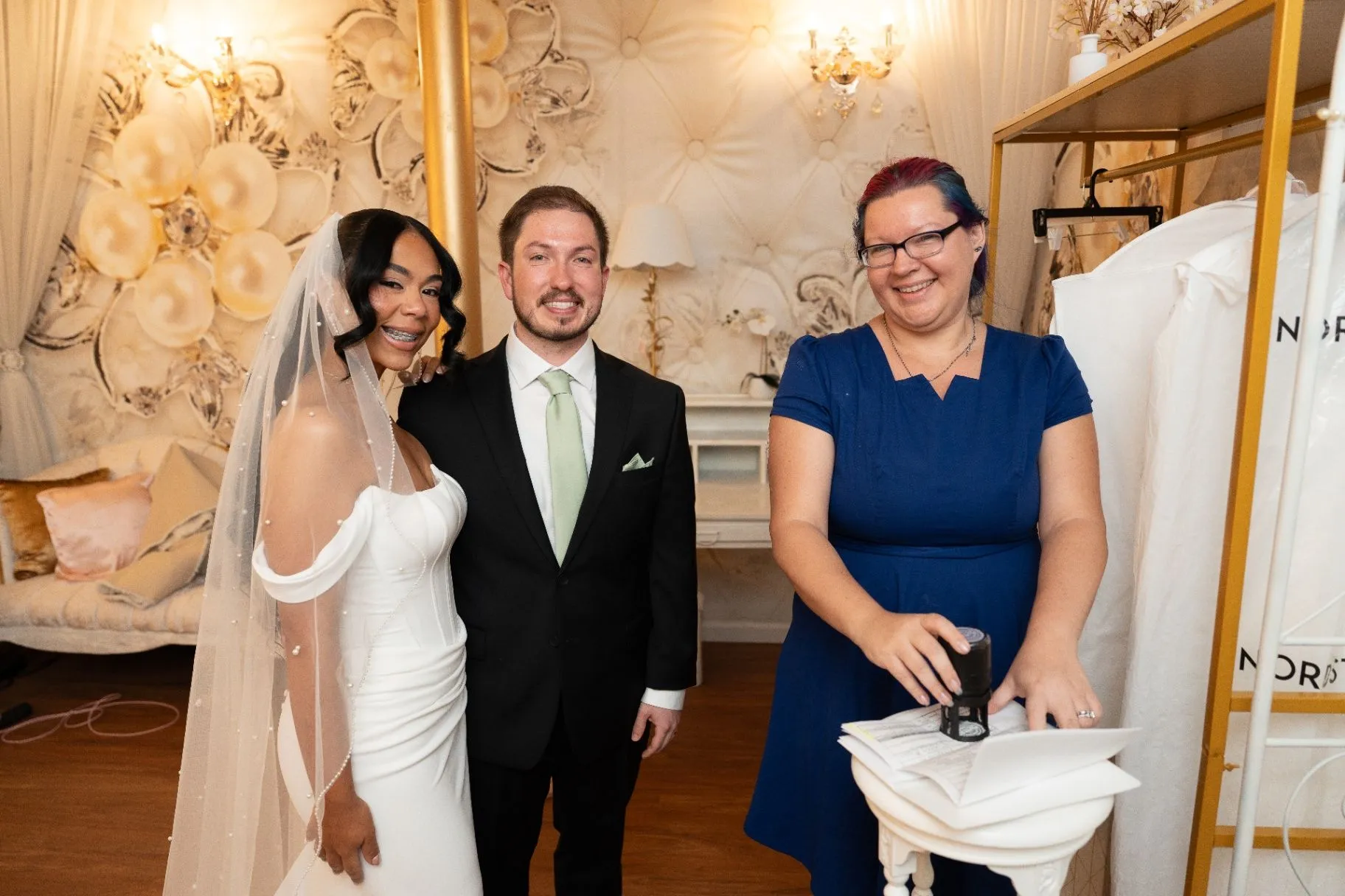 Notary signing the marriage license with the couple